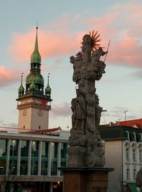 Statue of building against cloudy sky