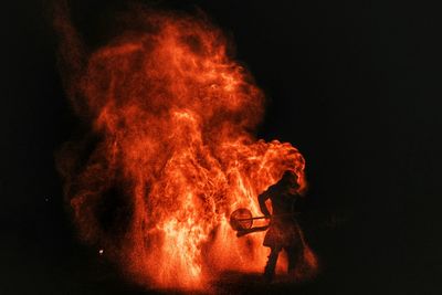 Man with fire crackers at night