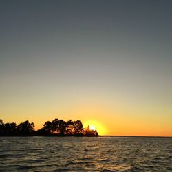 Scenic view of sea against clear sky during sunset