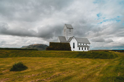 House on field against sky