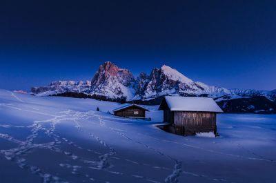 Snowcapped mountains against clear blue sky during winter