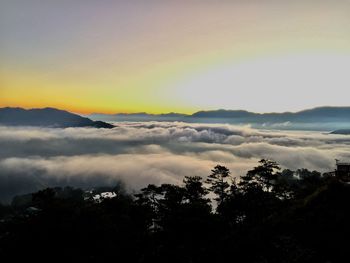 Scenic view of silhouette mountains against sky at sunset