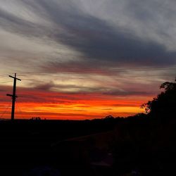 Silhouette of landscape against cloudy sky