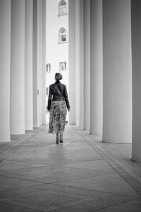 Full length rear view of man walking in building