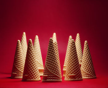 A group of empty waffles cones on red background