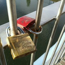 Close-up of padlocks on railing