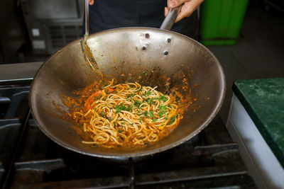 Photo of spaghetti with sauce in a wok