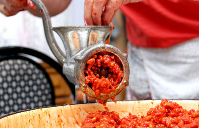 Close-up of hand pouring drink in plate