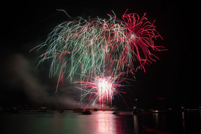 Low angle view of firework display at night