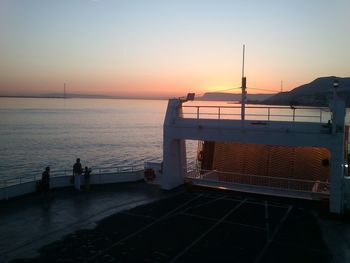 Pier on sea at sunset