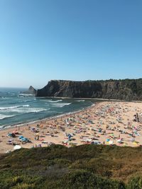 Scenic view of beach against clear blue sky