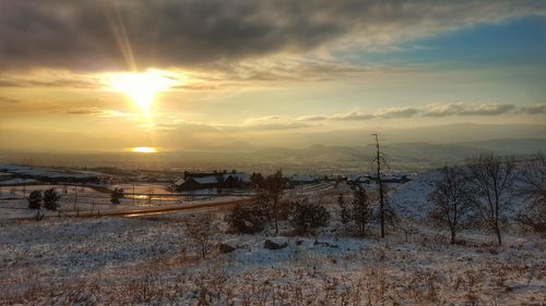 Scenic view of field against sky during sunset