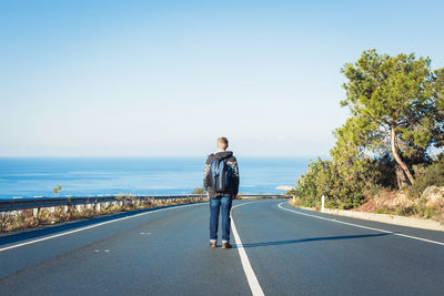 Man standing on road against clear sky