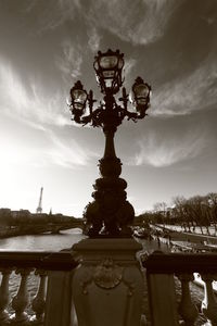 Statue in city against sky