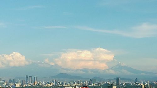 Scenic view of mountains against cloudy sky