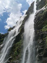 Low angle view of waterfall against sky