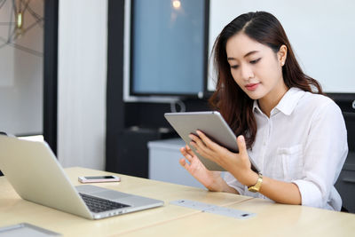 Businesswoman using laptop at office