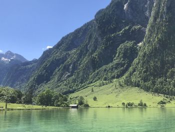 Scenic view of lake and mountains against sky