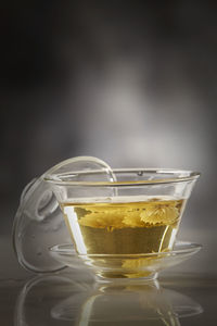 Close-up of chrysanthemum tea  in glass on table