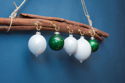 Close-up of multi colored hanging over blue background
