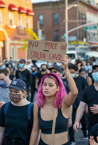 Group of people standing on street in city