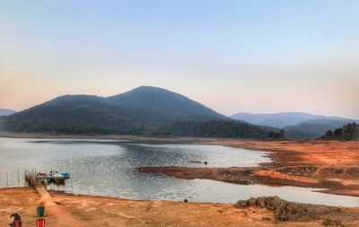 Scenic view of lake and mountains against clear sky