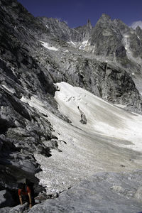 High angle view of man hiking on snowcapped mountain