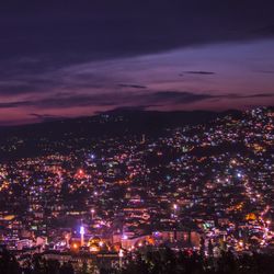 High angle view of illuminated buildings in city at night