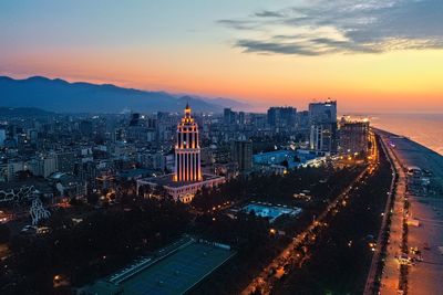 High angle view of illuminated buildings against sky during sunset