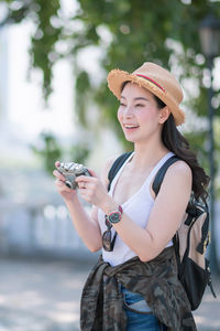 Young woman using mobile phone outdoors