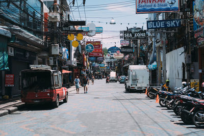 Cars on street amidst buildings in city