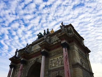 Low angle view of historical building against cloudy sky