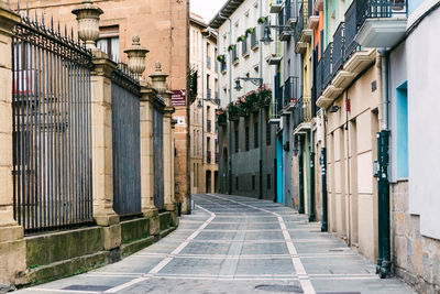 Empty footpath amidst buildings in town