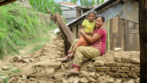 Happy girl sitting on floor at farm