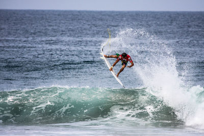 People surfing in sea