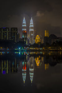 Reflection of illuminated buildings in city at night