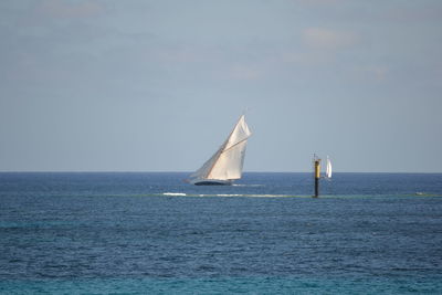 Boat sailing in sea against sky