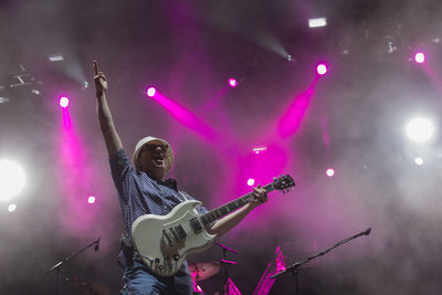 Low angle view of illuminated lighting equipment at night