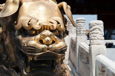 Close-up of statue against building