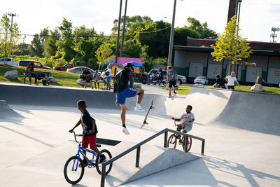 People riding bicycle on street in city