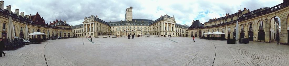 Buildings against cloudy sky