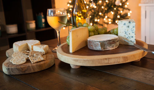 Cheese plate and wine including chardonnay, gourmet crackers, a washed rind soft cheese