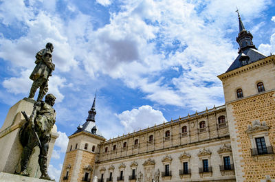 Low angle view of building against cloudy sky