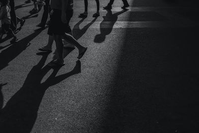 Low section of people walking on street 