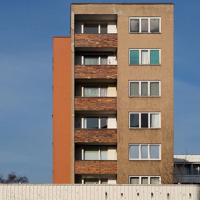 architecture, building exterior, built structure, window, low angle view, building, residential building, residential structure, city, repetition, apartment, clear sky, balcony, in a row, glass - material, facade, modern, day, no people, exterior