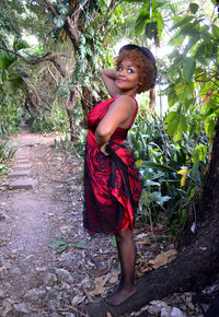 Young woman smiling while standing on tree park