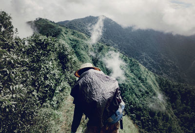 Rear view of man walking on mountain