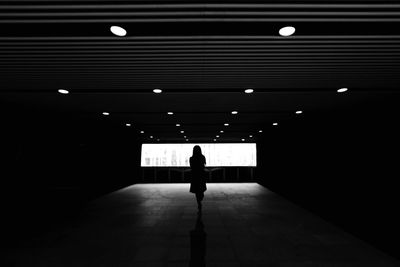 Woman walking in tunnel