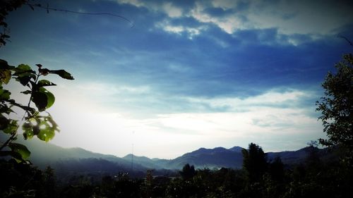 Scenic view of mountains against cloudy sky