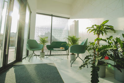 Empty chairs and tables in glass window